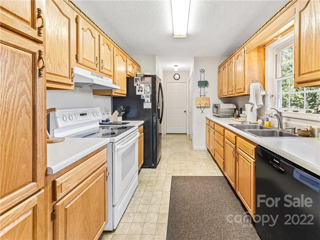 4411 Eller Ford Road Weaverville, NC 28787 - Photo 10 of 20 a kitchen with stainless steel appliances granite countertop a stove a sink and a refrigerator
