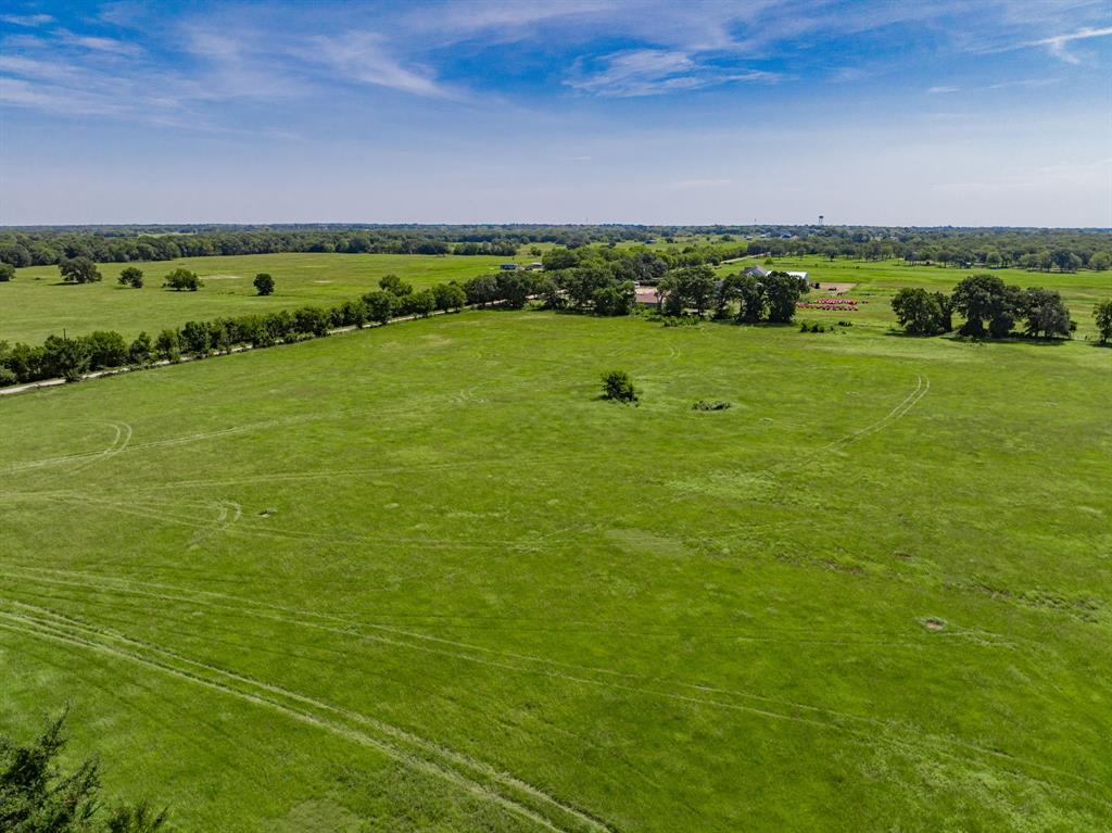 Lot 2 Co Road Kemp, TX 75143 - Photo 15 of 17 Expansive green acreage featuring a scattered tree line and distant agricultural structures