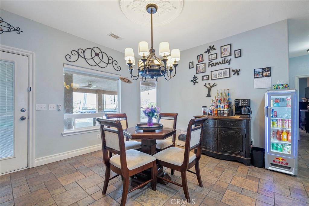 7172 Jargon Road Hesperia, CA 92344 - Photo 21 of 75 a dining room with furniture a chandelier and wooden floor