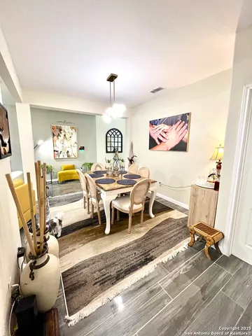 a living room with furniture gym equipment and a view of kitchen
