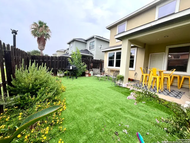a front view of a house with a yard table and chairs