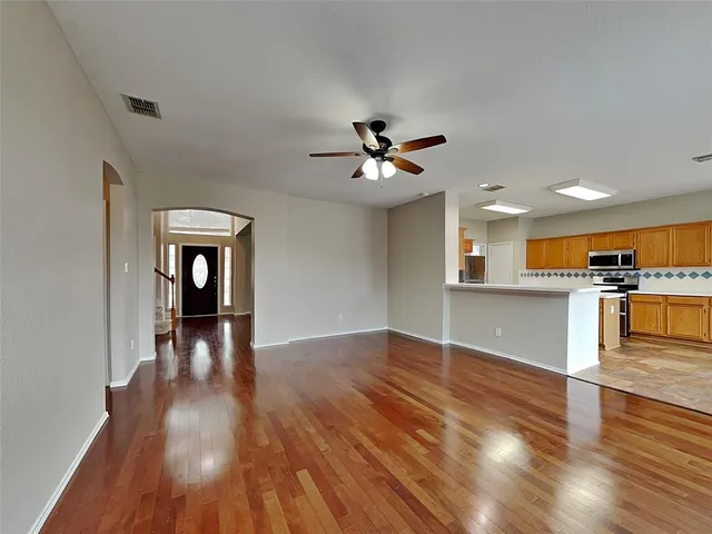 a view of an empty room and wooden floor