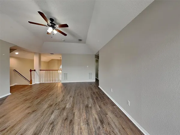 a view of an empty room and wooden floor