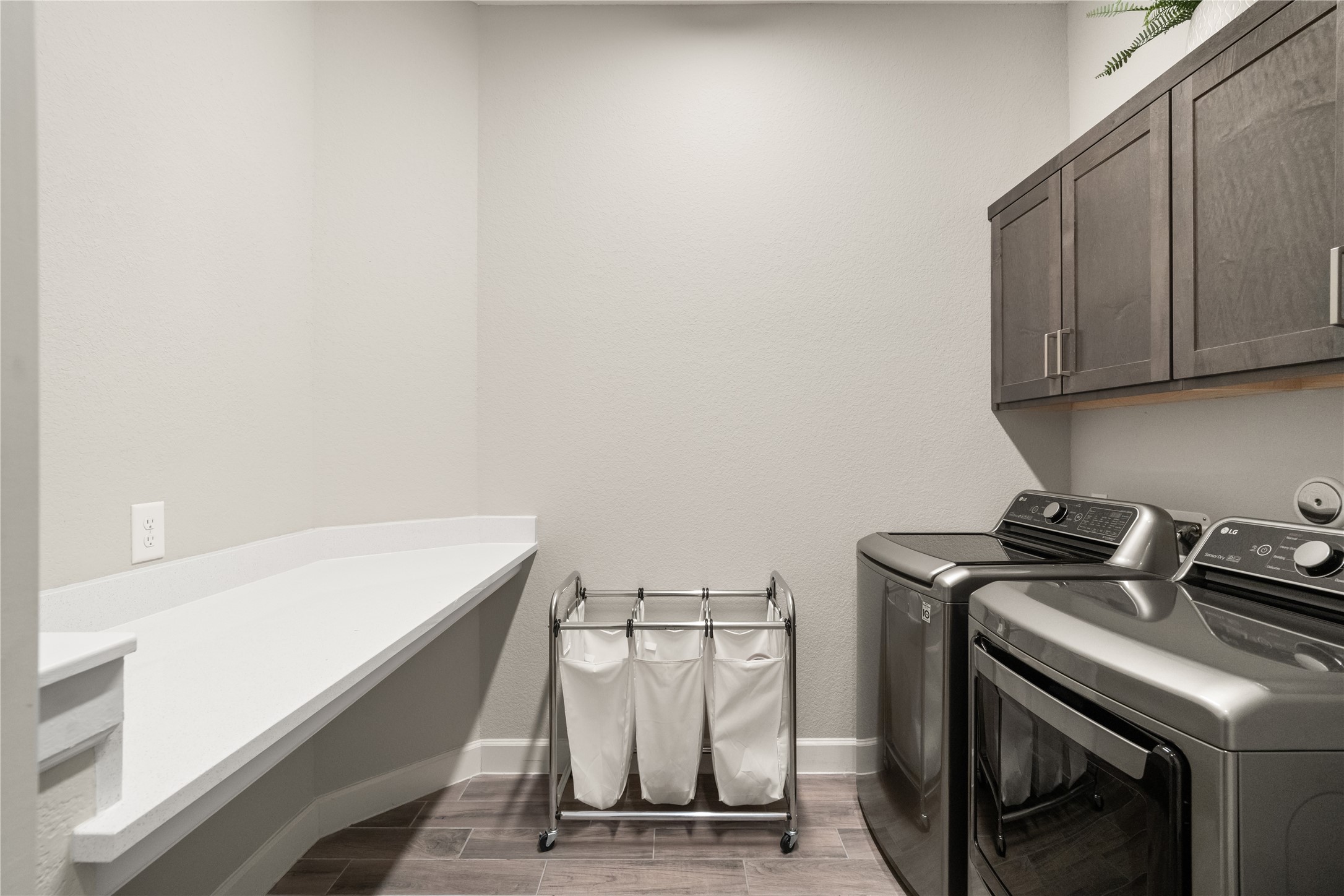 3118 Swift Way Katy, TX 77493 - Photo 24 of 34 Laundry Room – A dedicated laundry area with upper cabinetry and room for full-size appliances, designed for efficiency and extra storage.