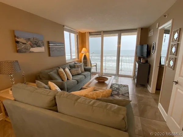 a living room with furniture and a large window