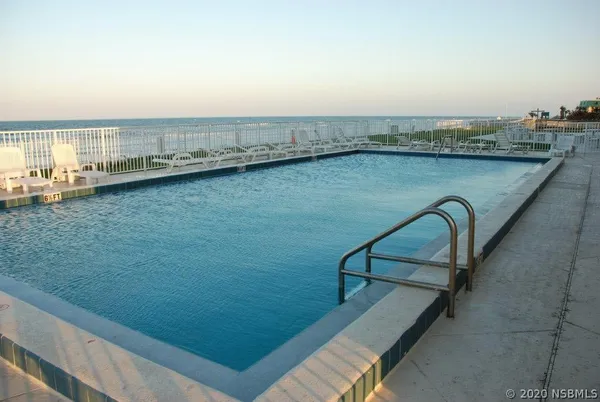 a bathroom with a granite countertop toilet sink and mirror