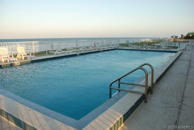 a bathroom with a granite countertop toilet sink and mirror