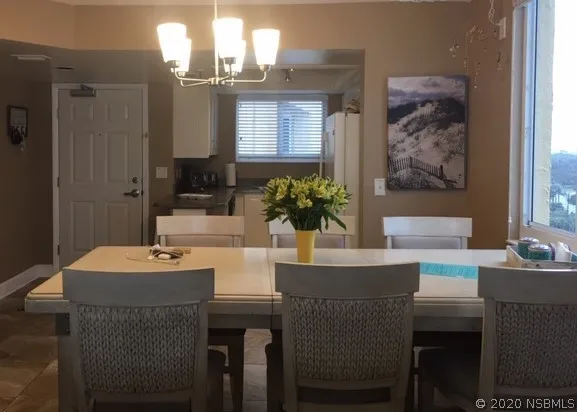 a dining room with furniture and window