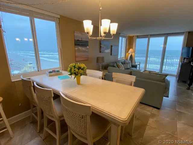a dining room with furniture and wooden floor