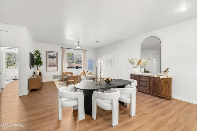 a view of a dining room with furniture and wooden floor