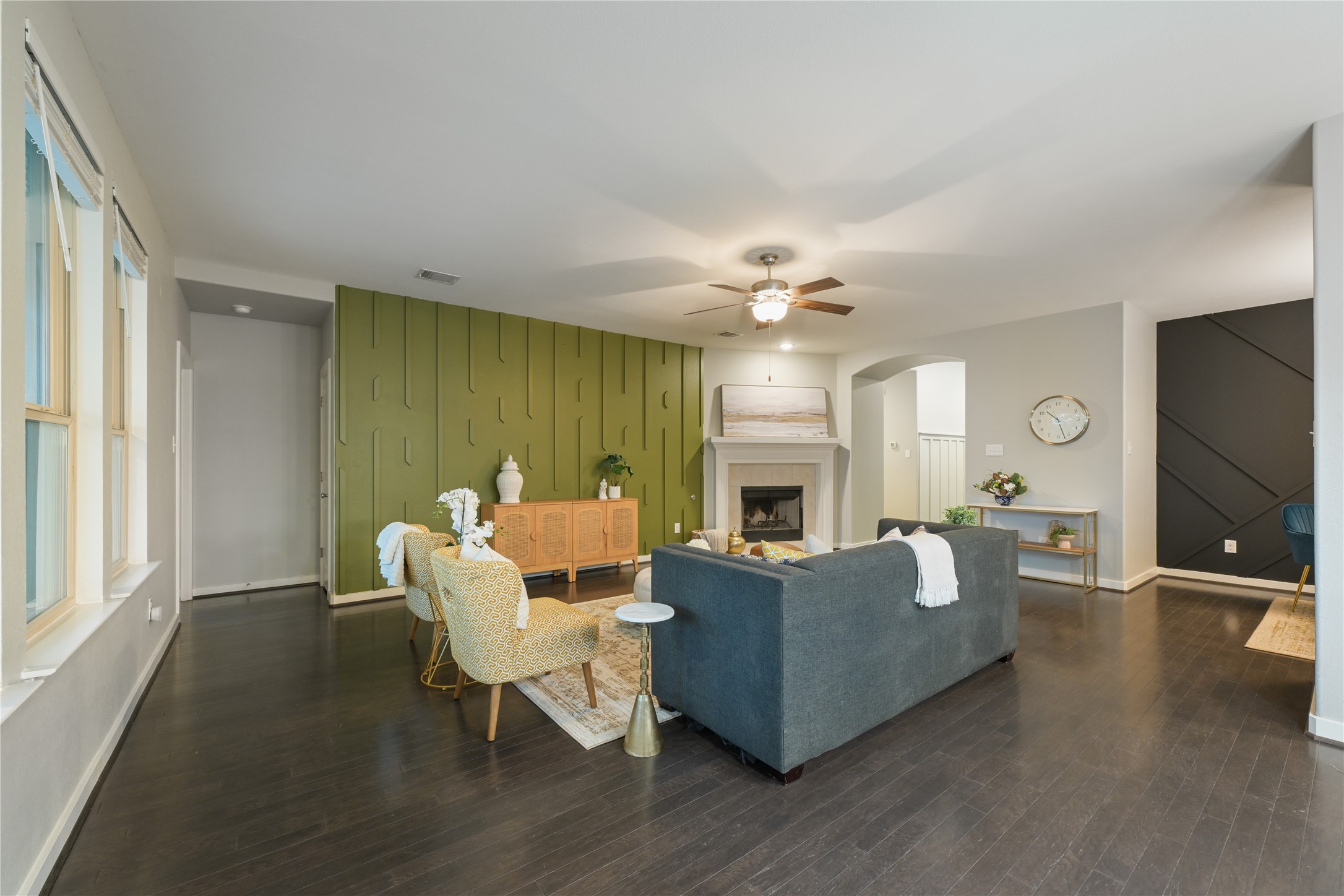 188 Nautical Loop Kyle, TX 78640 - Photo 13 of 38 Hardwood floors stretch across this living space, highlighting a modern fireplace and chic accent walls.
