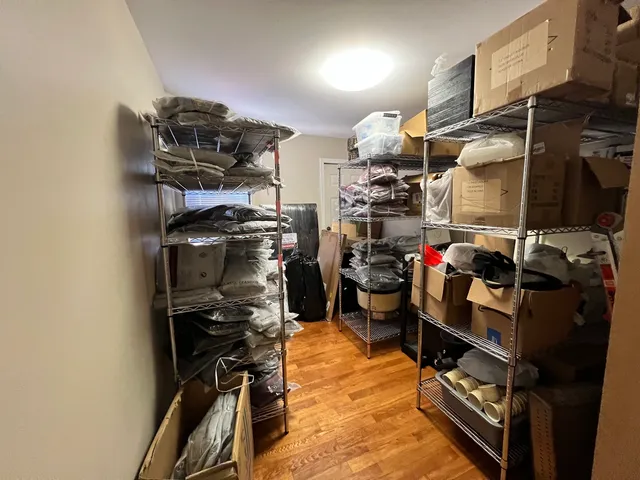 a view of walk in closet with clothes and shoes