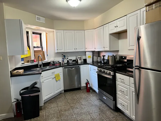 a kitchen with a refrigerator stove and sink