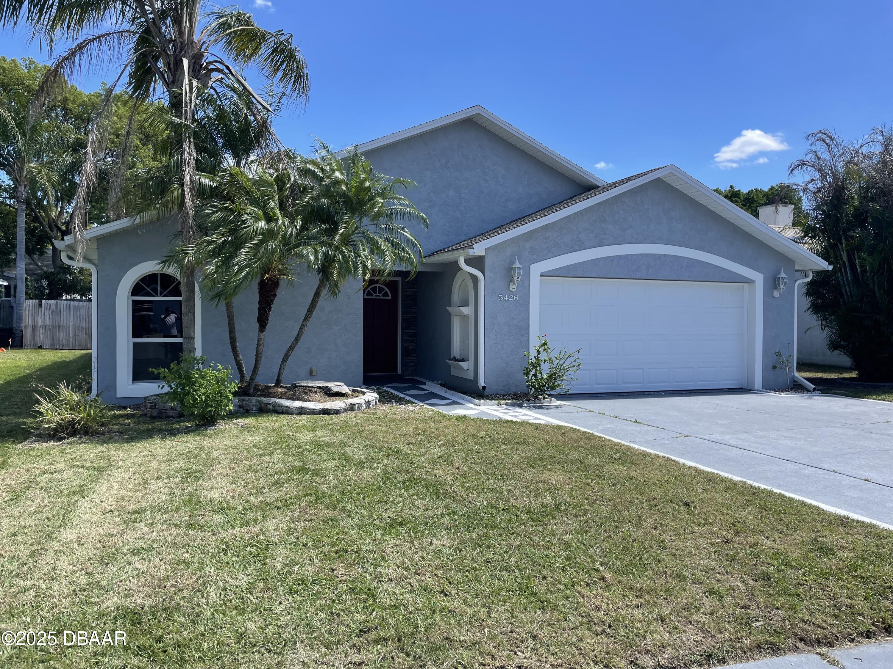 5426 Landis Avenue Port Orange, FL 32127 - Photo 1 of 30 a front view of a house with a yard and garage
