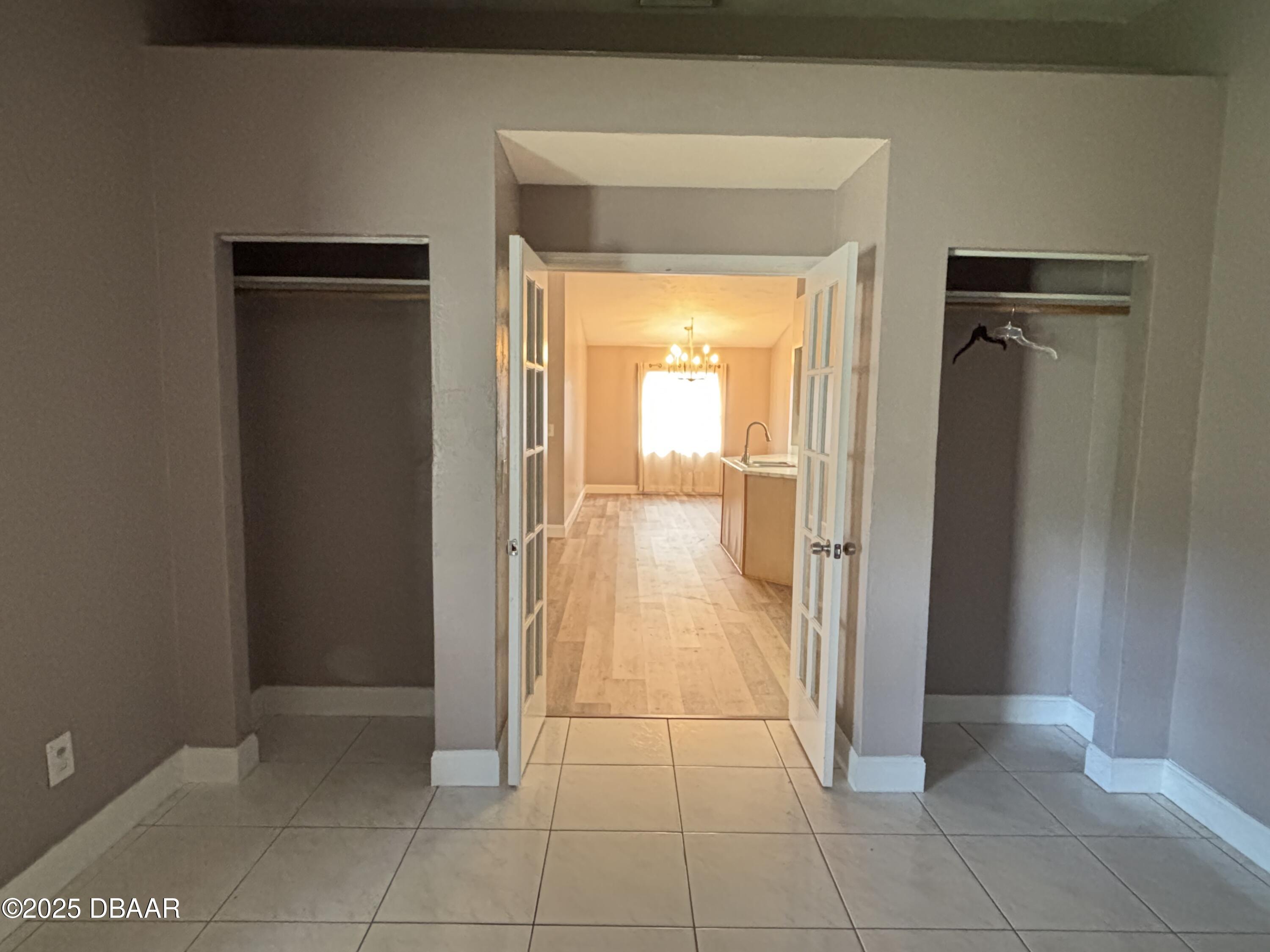 5426 Landis Avenue Port Orange, FL 32127 - Photo 16 of 30 a view of a hallway with wooden floor and a bathroom