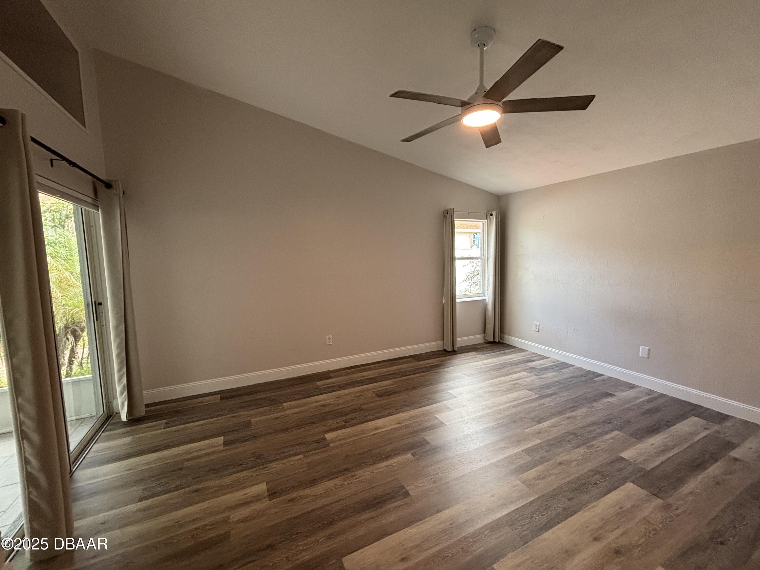 5426 Landis Avenue Port Orange, FL 32127 - Photo 17 of 30 an empty room with wooden floor and windows