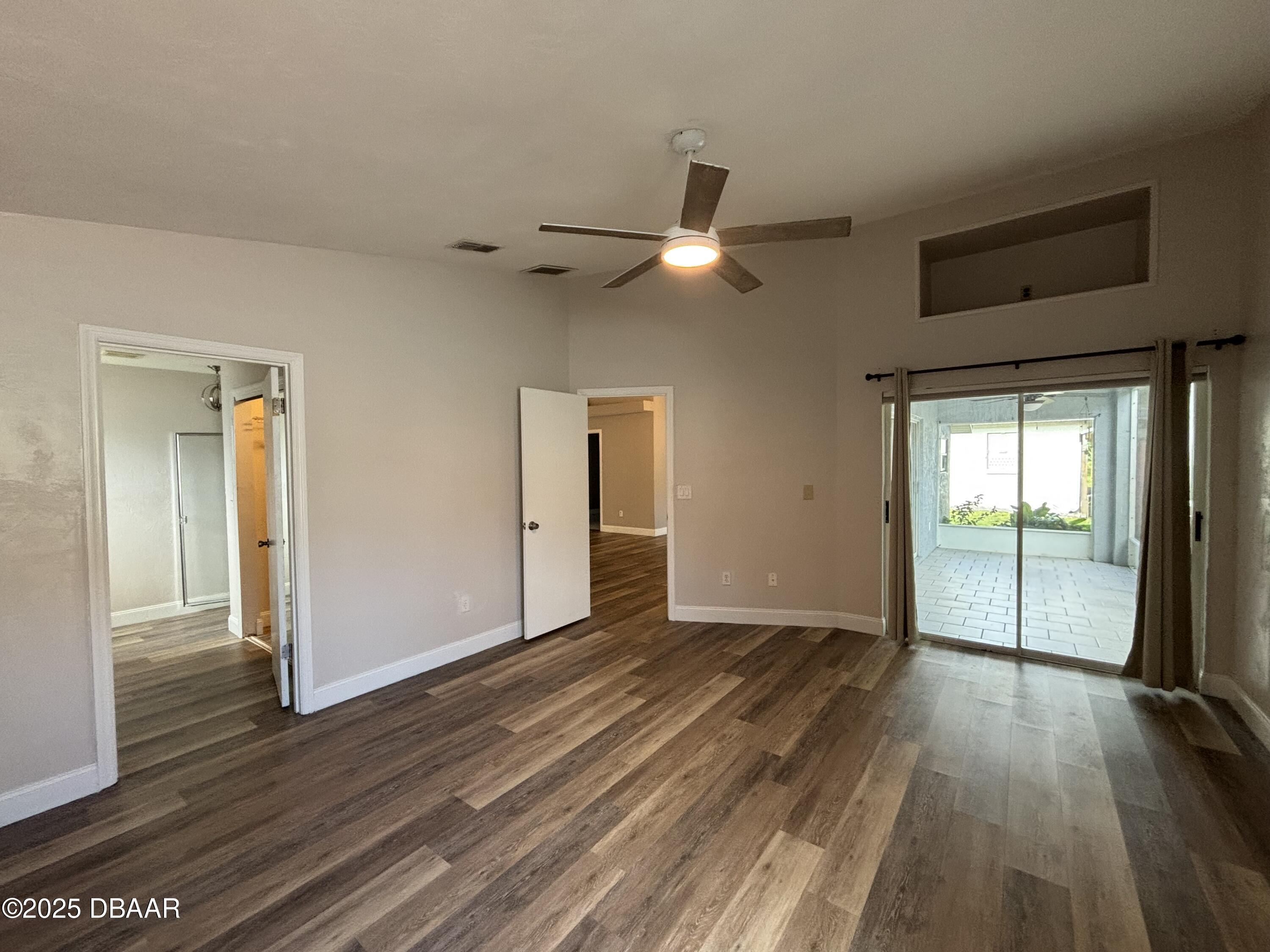 5426 Landis Avenue Port Orange, FL 32127 - Photo 18 of 30 a view of empty room with wooden floor and fan