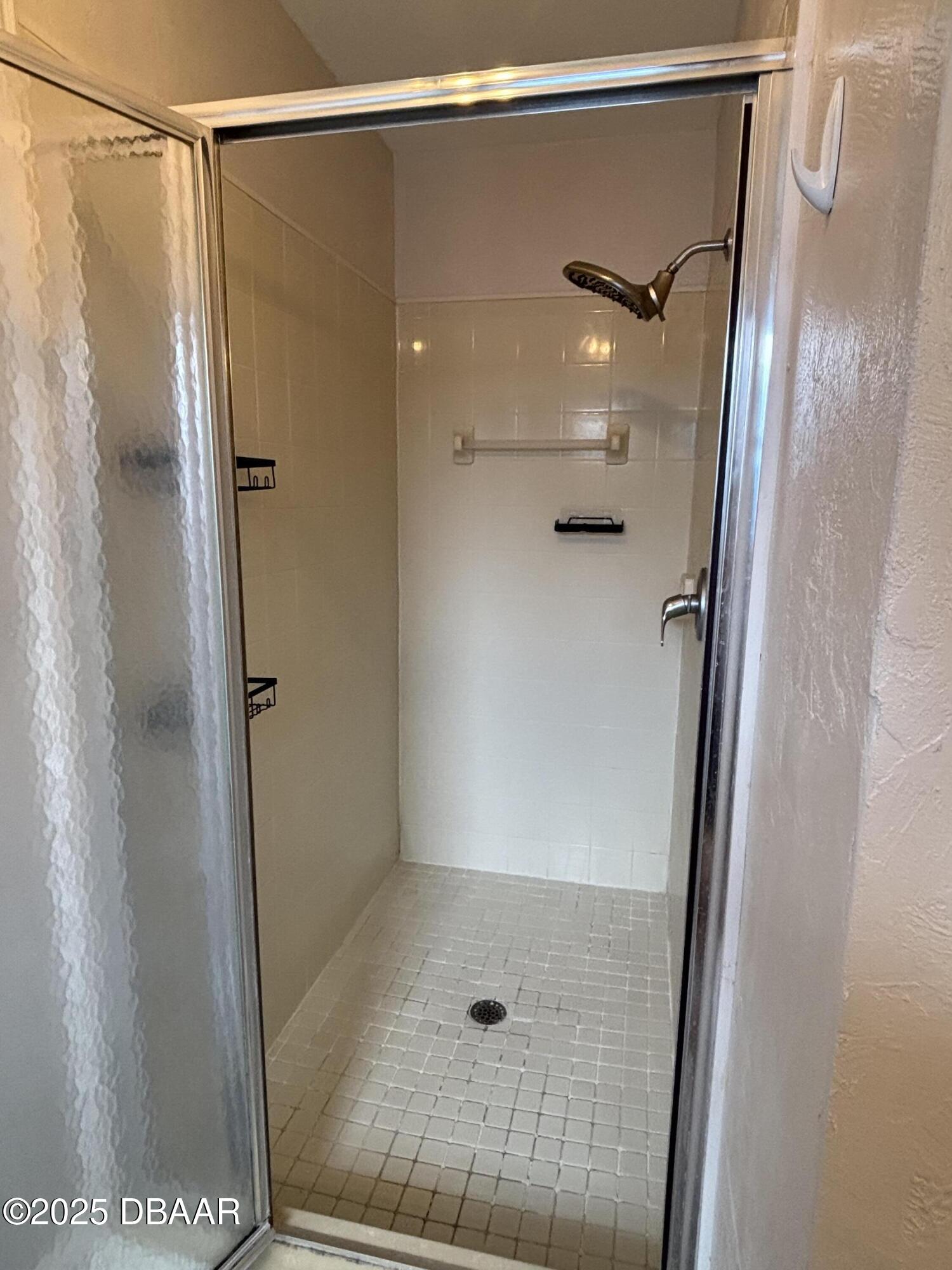 5426 Landis Avenue Port Orange, FL 32127 - Photo 20 of 30 a bathroom with a glass shower door