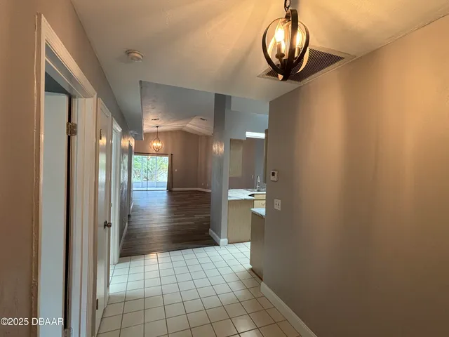a view of hallway with chandelier