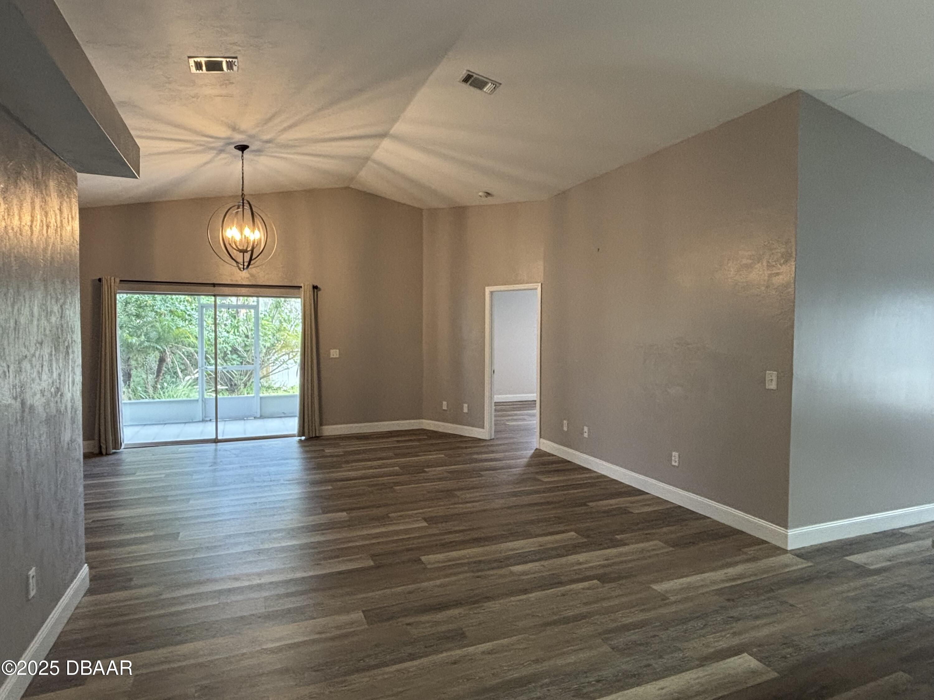 5426 Landis Avenue Port Orange, FL 32127 - Photo 3 of 30 a view of an empty room with wooden floor and a window