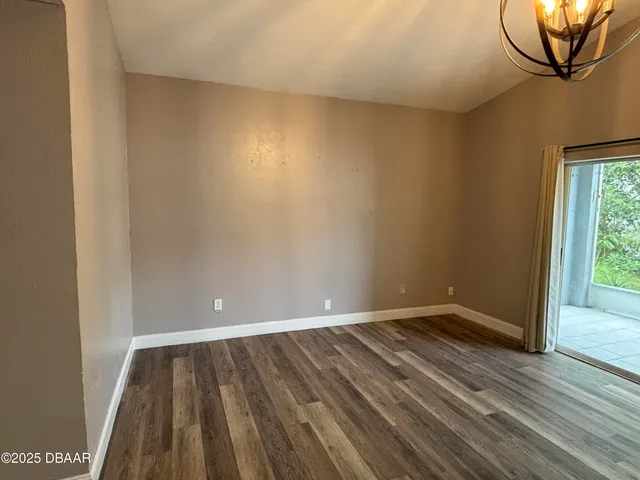 a view of room with window and wooden floor
