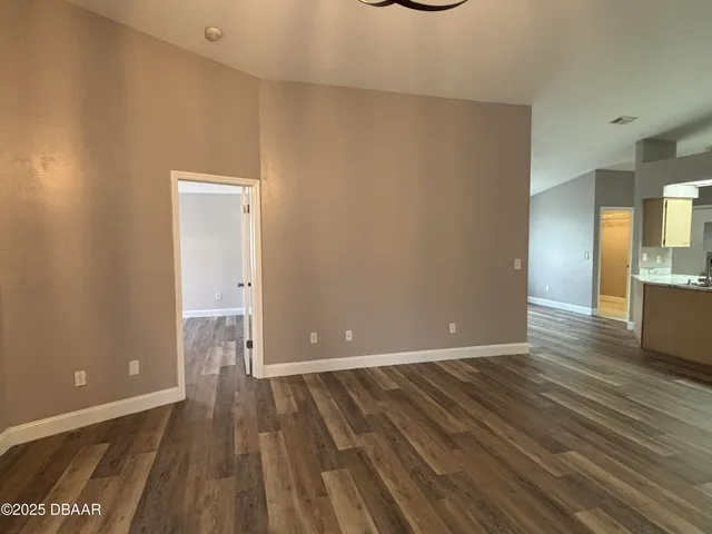 a view of a room with wooden floor and a bathroom