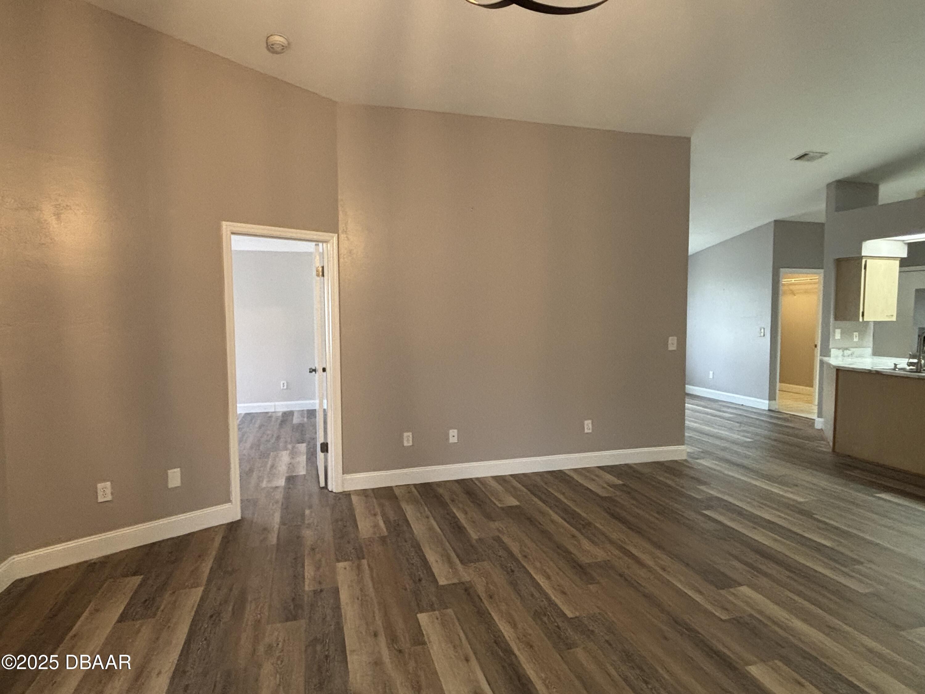 5426 Landis Avenue Port Orange, FL 32127 - Photo 5 of 30 a view of a room with wooden floor and a bathroom