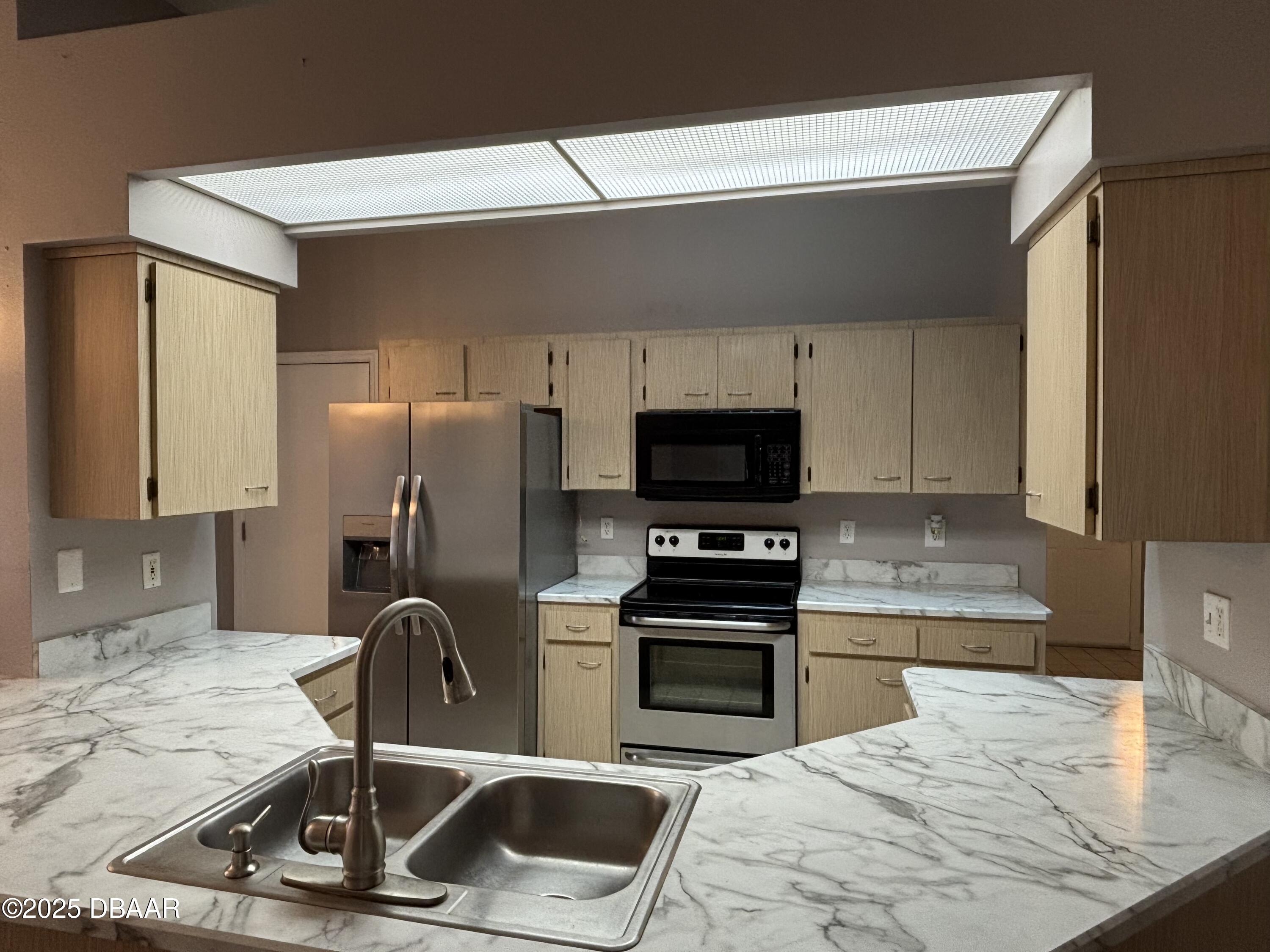 5426 Landis Avenue Port Orange, FL 32127 - Photo 8 of 30 a kitchen with a sink a stove and a microwave