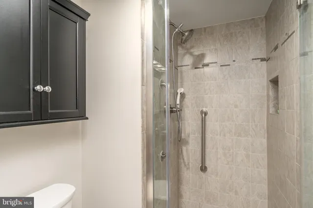 a bedroom with a large bed and a flat tv screen on dresser