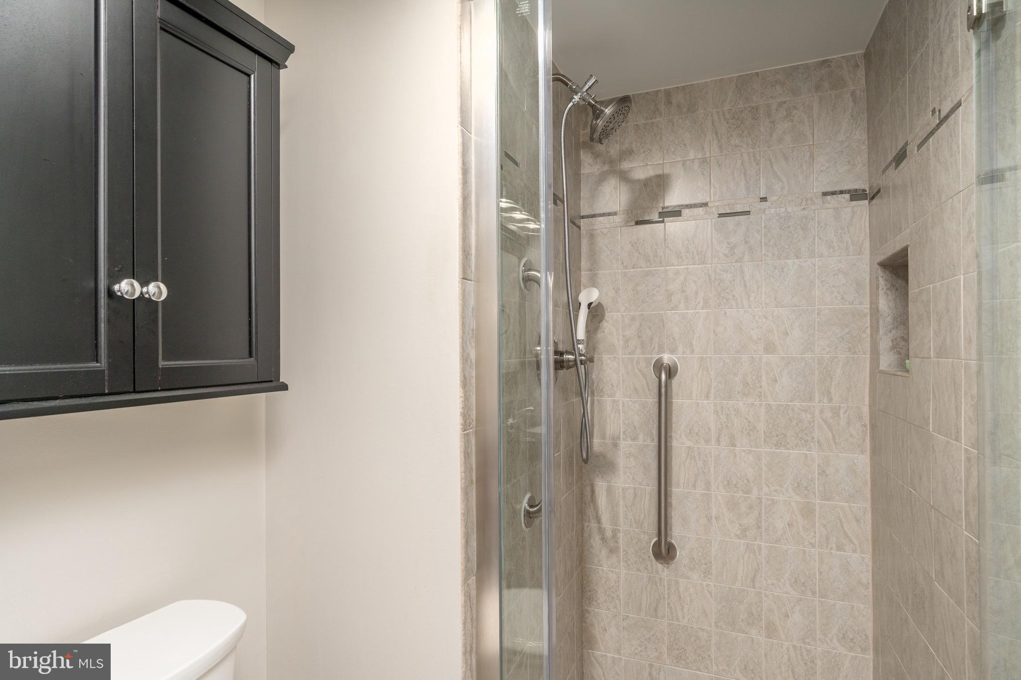 15101 Interlachen Drive, Unit 1612 Silver Spring, MD 20906 - Photo 23 of 37 Glass shower door and tiles