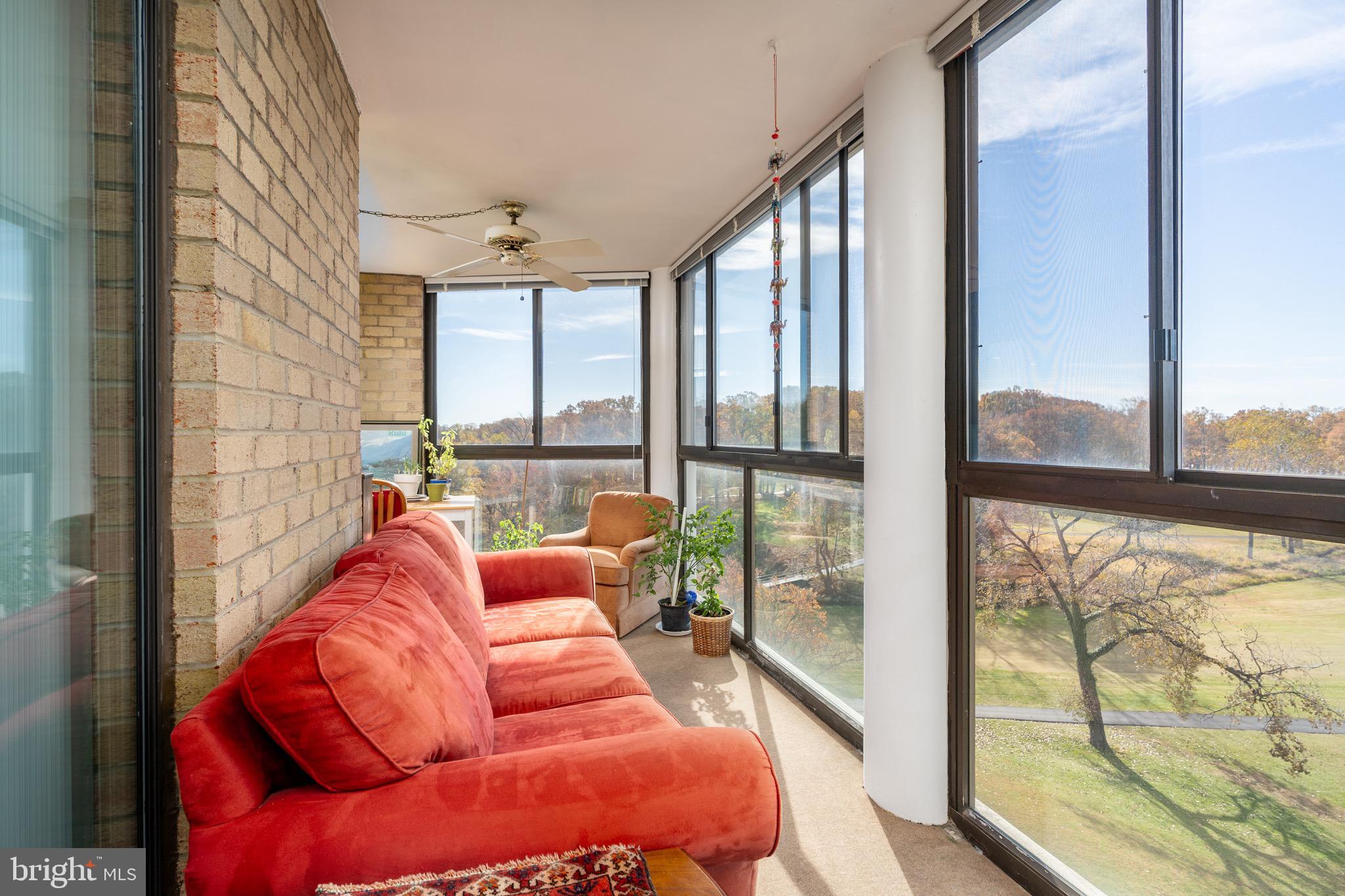 15101 Interlachen Drive, Unit 1612 Silver Spring, MD 20906 - Photo 5 of 37 Expansive sunroom with panoramic views