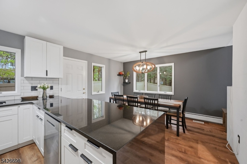 30 Eatontown Road West Milford, NJ 07421 - Photo 14 of 50 a kitchen with a table chairs and wooden floor