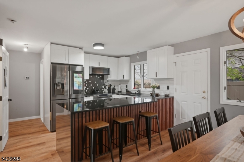 30 Eatontown Road West Milford, NJ 07421 - Photo 16 of 50 a kitchen with kitchen island a dining table chairs and refrigerator