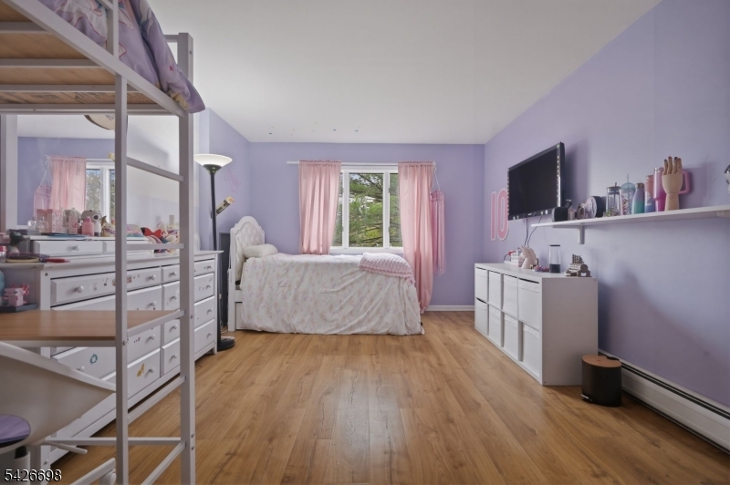 30 Eatontown Road West Milford, NJ 07421 - Photo 22 of 50 a spacious bedroom with a bed and a flat screen tv