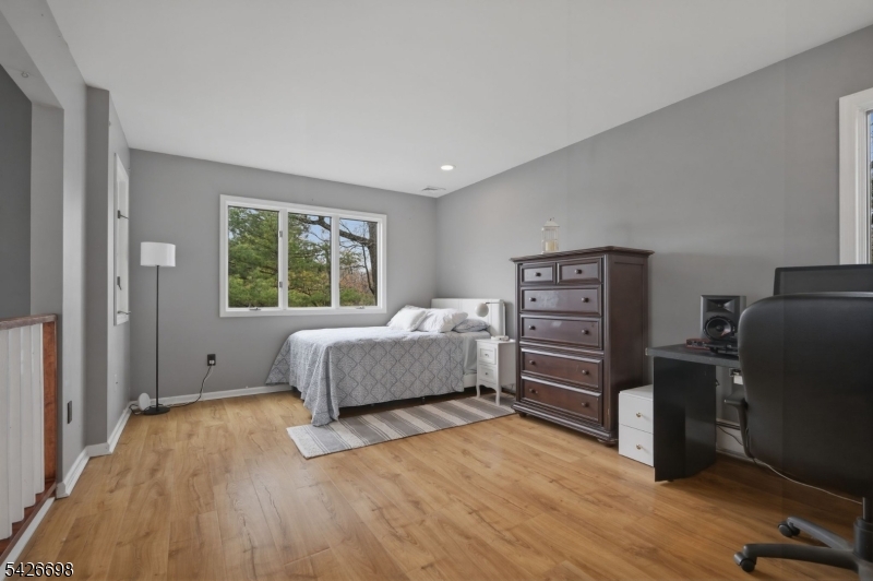 30 Eatontown Road West Milford, NJ 07421 - Photo 28 of 50 a bedroom with a bed and wooden floor