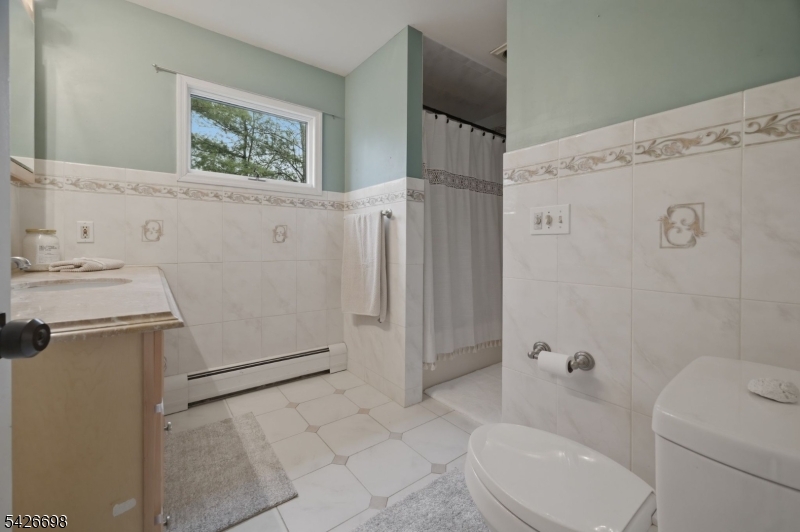 30 Eatontown Road West Milford, NJ 07421 - Photo 31 of 50 a bathroom with a sink toilet and shower