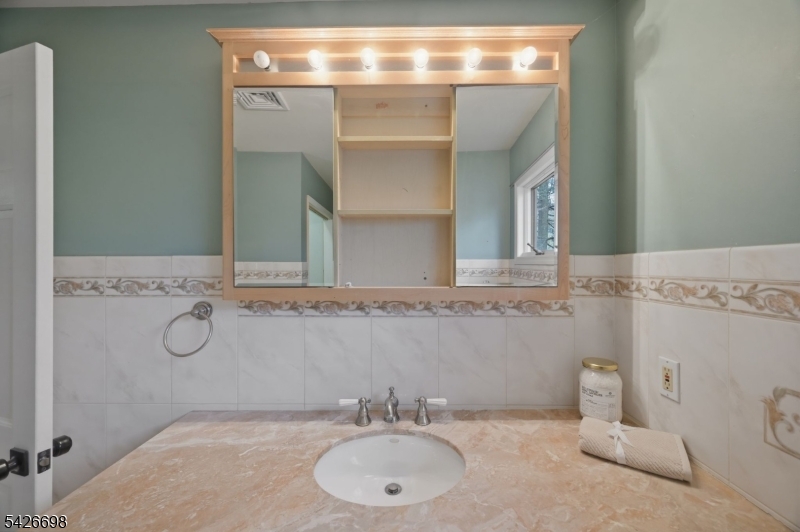 30 Eatontown Road West Milford, NJ 07421 - Photo 32 of 50 a bathroom with a sink and a mirror