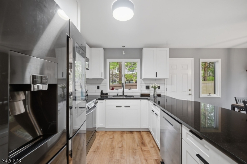 30 Eatontown Road West Milford, NJ 07421 - Photo 7 of 50 a kitchen with a sink stove and refrigerator