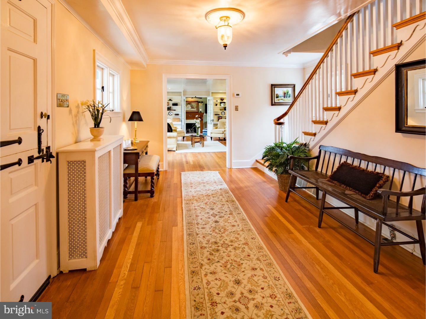 11 Forest Road Wayne, PA 19087 - Photo 3 of 25 a hallway with wooden floor stairs and furniture