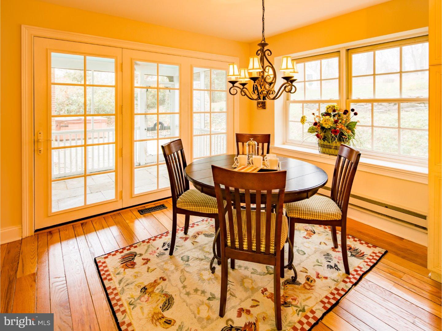 11 Forest Road Wayne, PA 19087 - Photo 10 of 25 a view of a dining room with furniture a chandelier and wooden floor