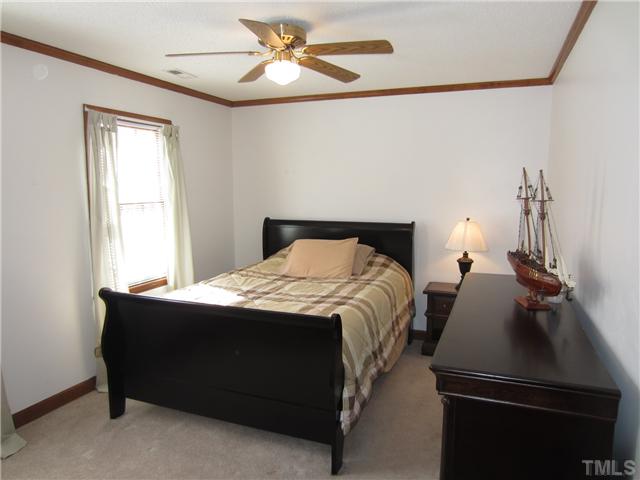 115 Brandywine Drive Raleigh, NC 27607 - Photo 15 of 25 a bedroom with a bed and a chandelier