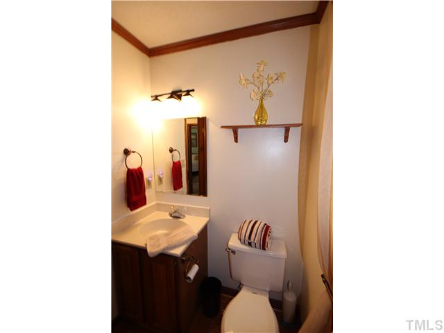 115 Brandywine Drive Raleigh, NC 27607 - Photo 17 of 25 a bathroom with a sink and a mirror