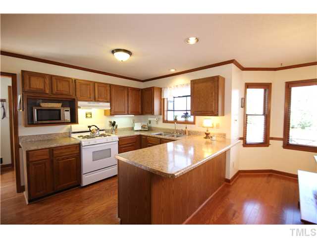 115 Brandywine Drive Raleigh, NC 27607 - Photo 7 of 25 a kitchen with stainless steel appliances granite countertop a sink stove and refrigerator