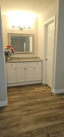 a view of a room with wooden floor and ceiling fan