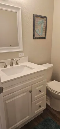 a view of a livingroom with wooden floor and white walls