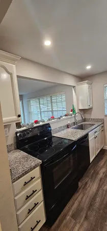 a kitchen with stainless steel appliances granite countertop a stove and a sink