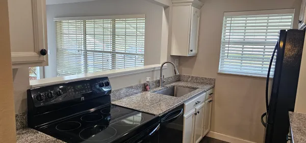 a kitchen with a stove and a sink