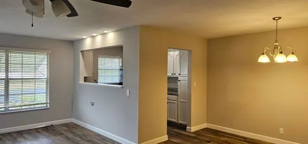 a view of a room with wooden floor closet and windows