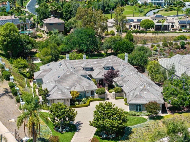 an aerial view of multiple houses with yard
