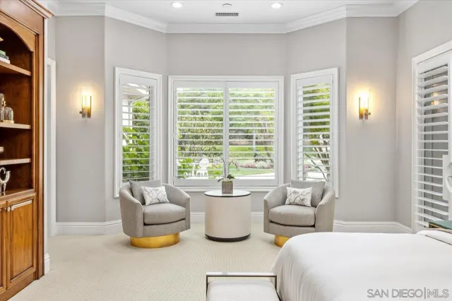 a spacious bedroom with a bed and a television